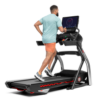 Man using the touchscreen on the Treadmill 56 --thumbnail