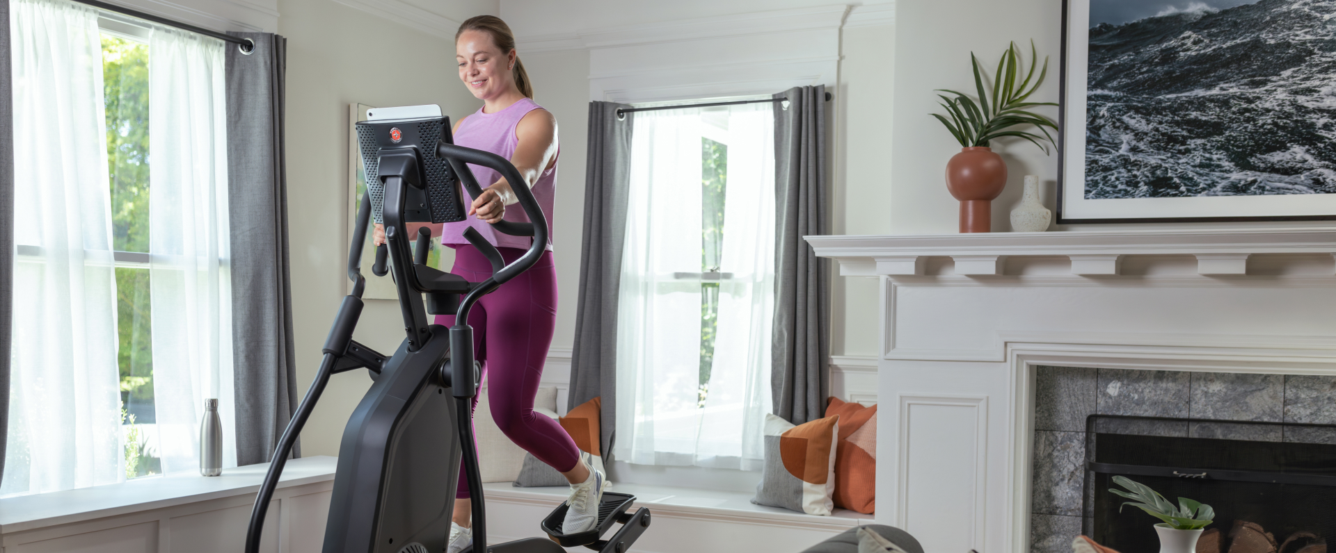 Woman in her living room riding a Schwinn 590 