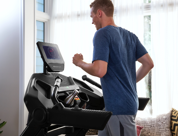 man running on a Treadmill 10 in a house