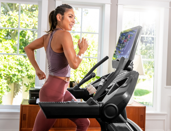 woman running on a Treadmill 56 in a sunny room