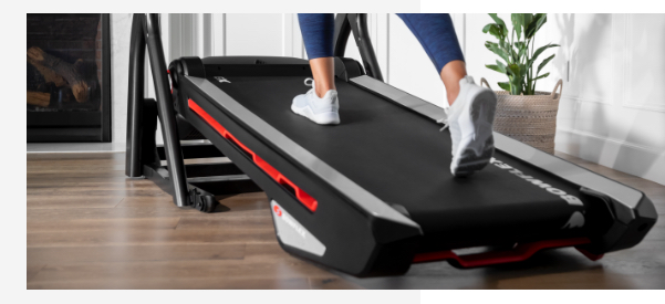 A woman using treadmill with incline